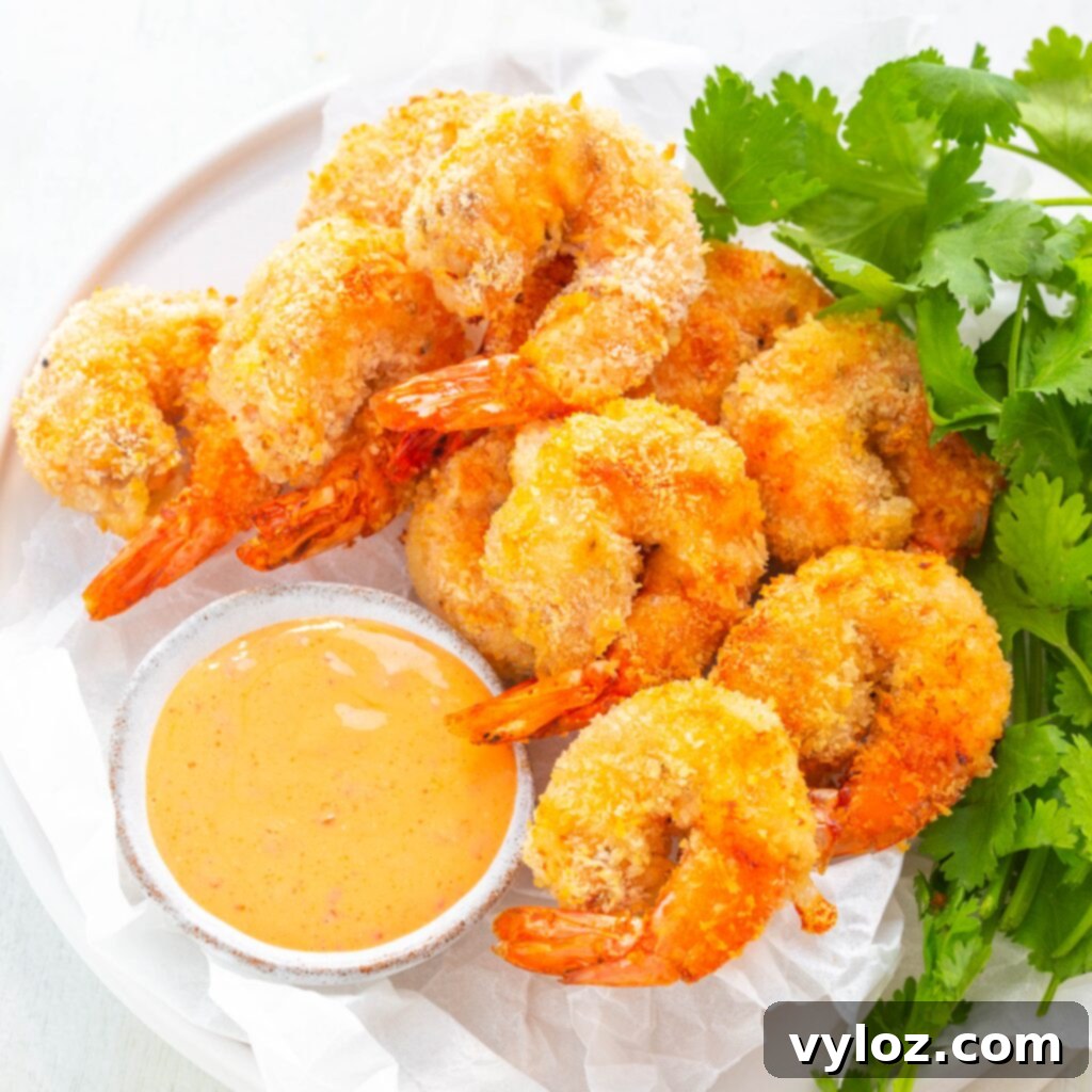 Crispy Air Fryer Bang Bang Shrimp 13 Air Fryer Bang Bang Panko Breaded Fried Shrimp on a white plate served with a spicy sweet chili sauce