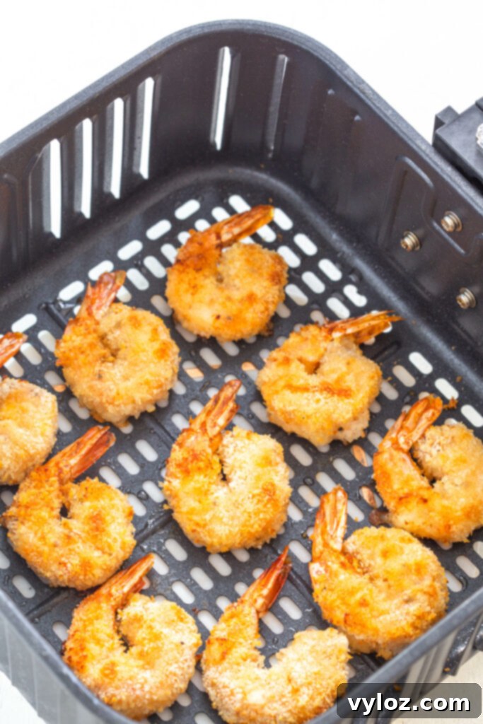Crispy Air Fryer Bang Bang Shrimp 6 Crispy fried shrimp cooking in an air fryer basket