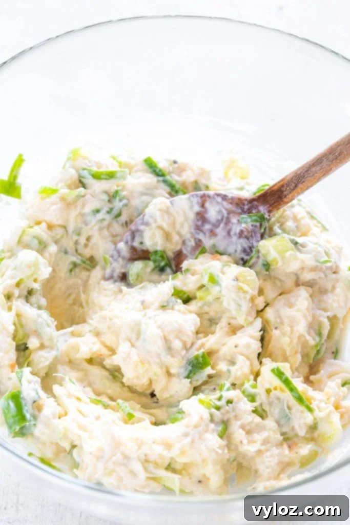 Crispy Air Fryer Crab Rangoon Delights 6 Creamy crab rangoon filling mixed in a clear glass bowl, ready to be scooped into wonton wrappers.