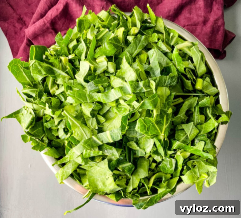 Clean collard greens soaking in water in a large bowl