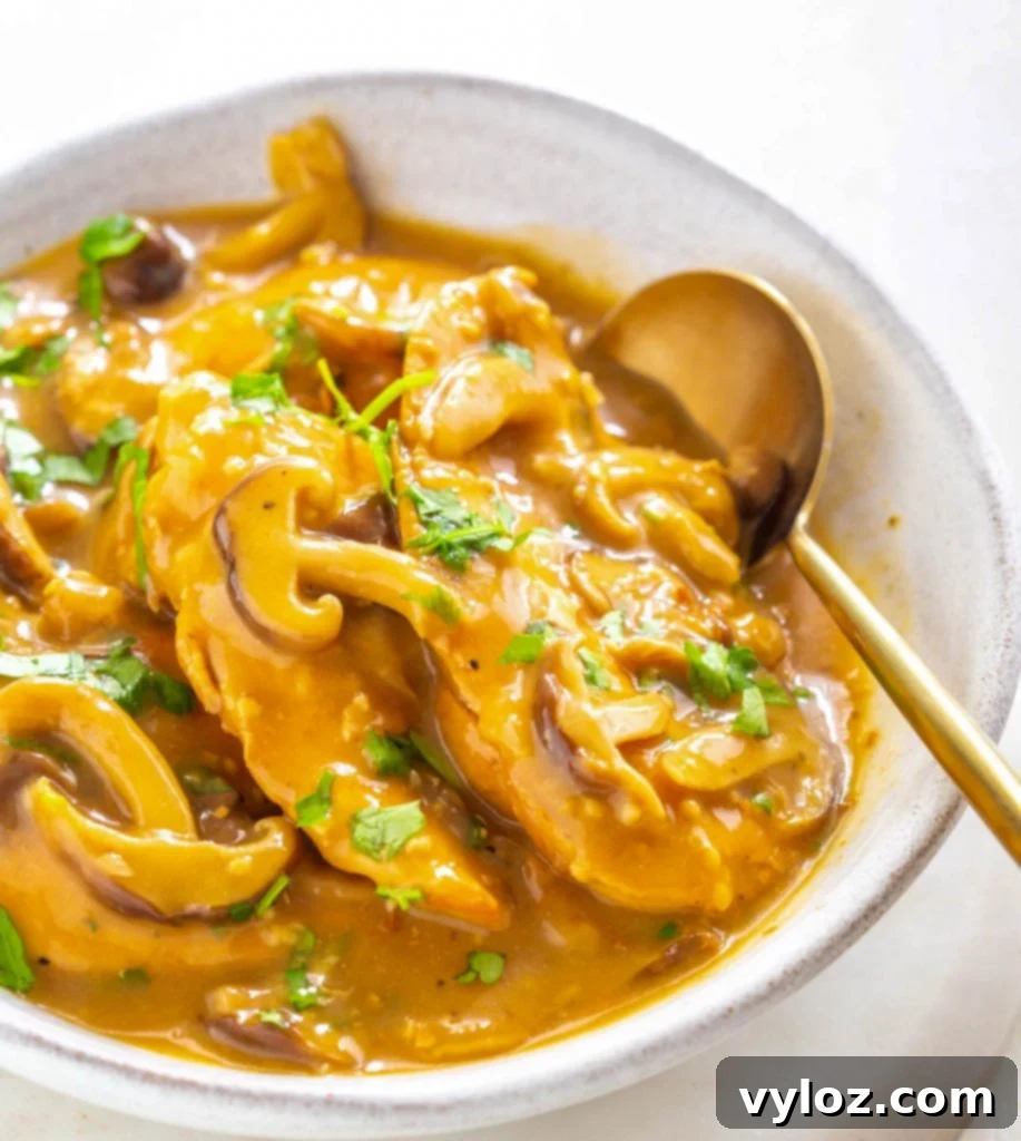 Instant Pot Chicken Marsala in a white bowl, garnished with fresh parsley.
