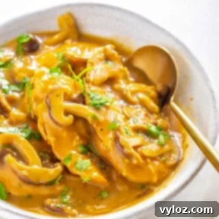 Instant Pot Chicken Marsala in a serving dish on a multicolored surface.