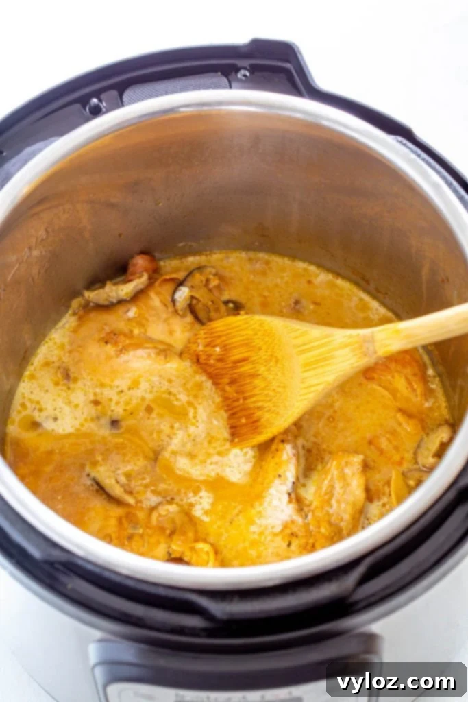 Chicken Marsala simmering in an Instant Pot, with its rich sauce.