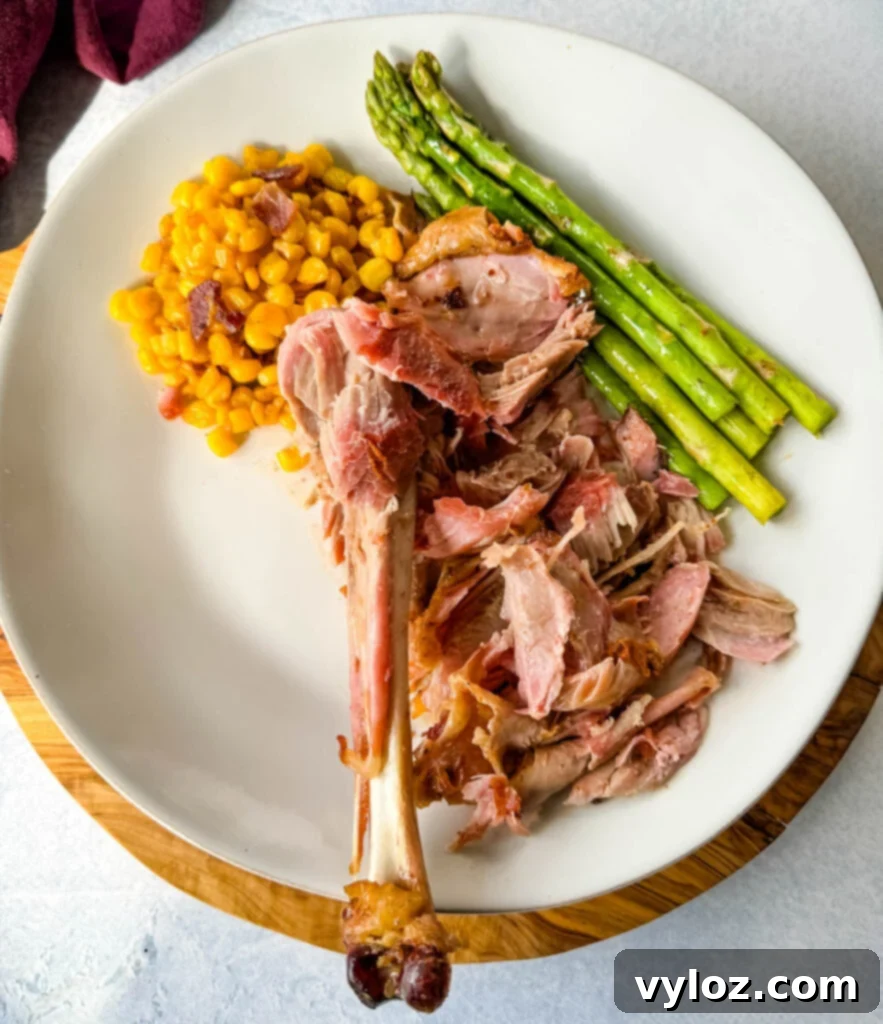 Fall-off-the-bone smoked turkey legs served on a plate with vibrant garnishes