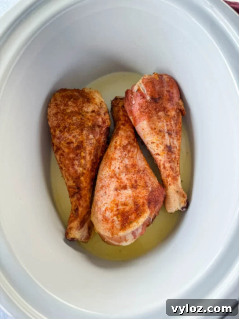 Smoked turkey legs transferred to a slow cooker for finishing