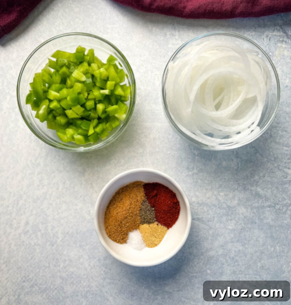 chopped green peppers, sliced onions, and spices in separate bowls
