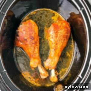 2 cooked turkey legs in a Crockpot slow cooker