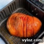 Honey-Kissed Air Fryer Ham 11 air fryer honey glazed ham on a green and gold plate