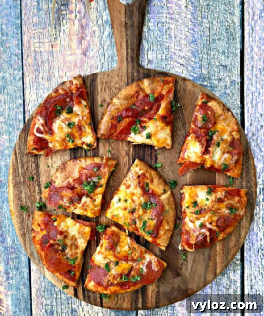 Crispy air fryer pepperoni pizza with melted mozzarella cheese on a vibrant, multi-colored surface