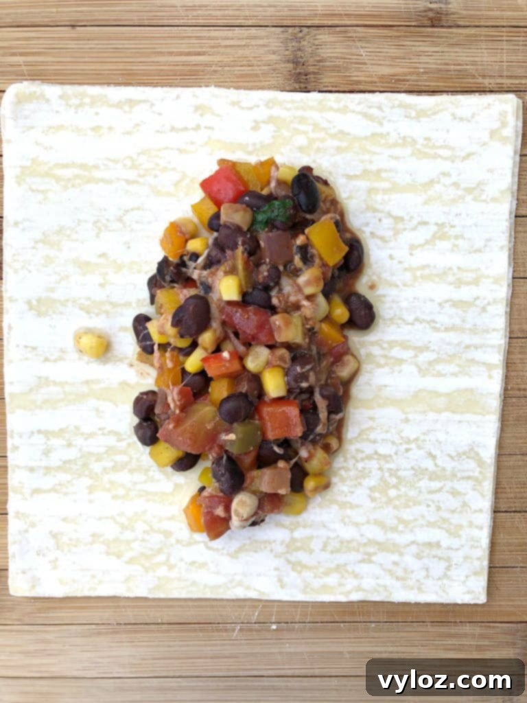 Close-up shot of egg roll filling inside an egg roll wrapper, demonstrating the preparation stage before folding.