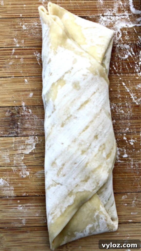 An uncooked egg roll wrapper filled with the Southwestern mixture, ready to be folded.