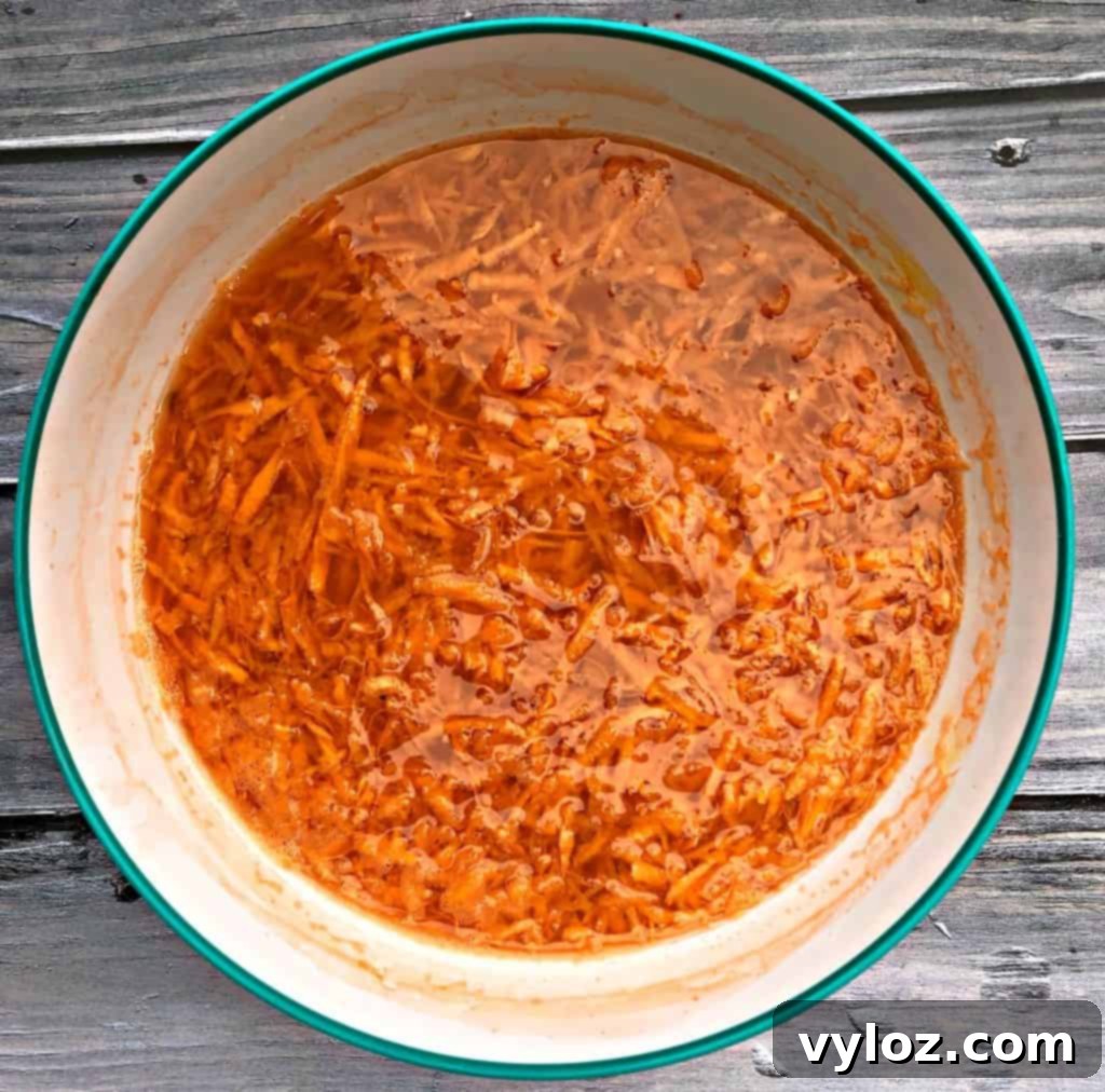Grated sweet potatoes soaking in cold water to remove starch for crispiness