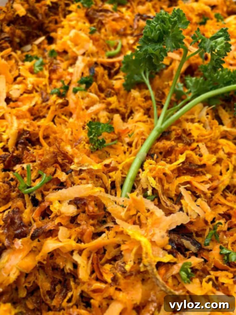 Close-up of crispy sweet potato hash browns garnished with parsley