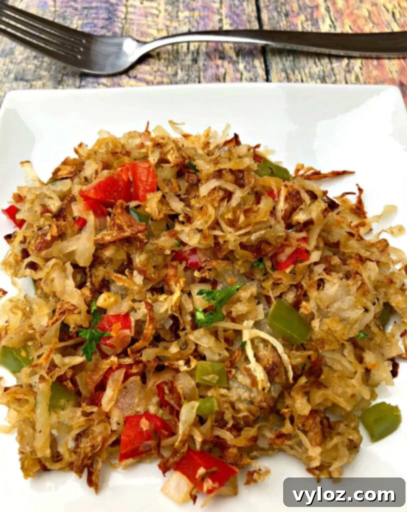 Perfectly Crispy Air Fryer Hash Browns 2 close up photo of air fryer hash browns on a white plate, showcasing their golden-brown crispiness