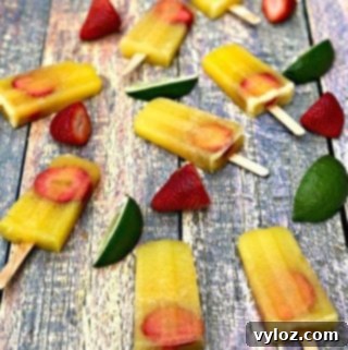 Adult Margarita Pops 12 Margarita popsicles on a flat surface with strawberries and limes