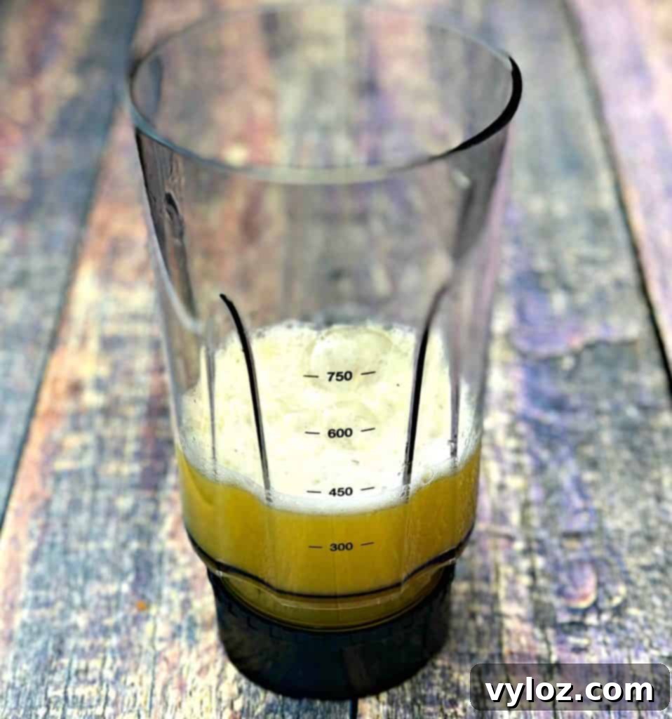 Adult Margarita Pops 4 Margarita mix in a blender on a colorful counter