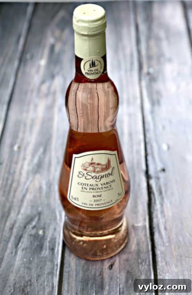 A glass of Rosé wine on a dark, elegant surface, highlighting its beautiful pink hue.