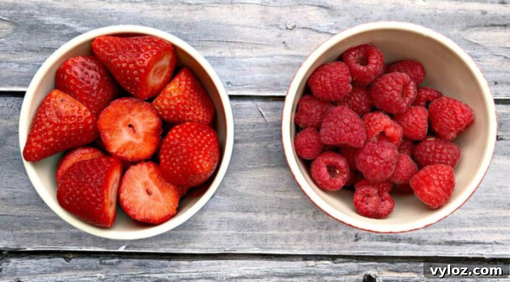 Fresh, vibrant strawberries and raspberries, ideal for making delicious fruit-infused popsicles.