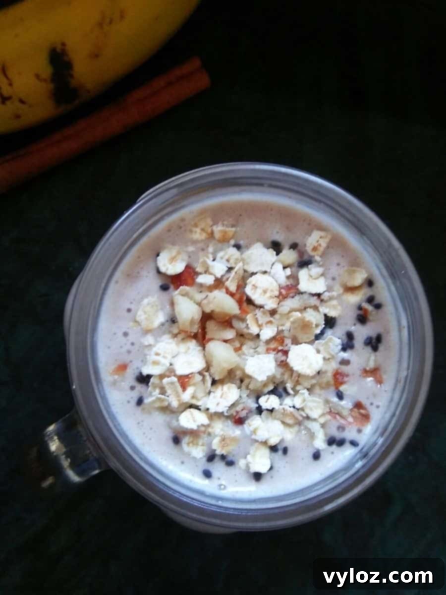 Oats Banana Breakfast Smoothie - a thick and creamy blend with oats, banana, and cinnamon, served in a glass