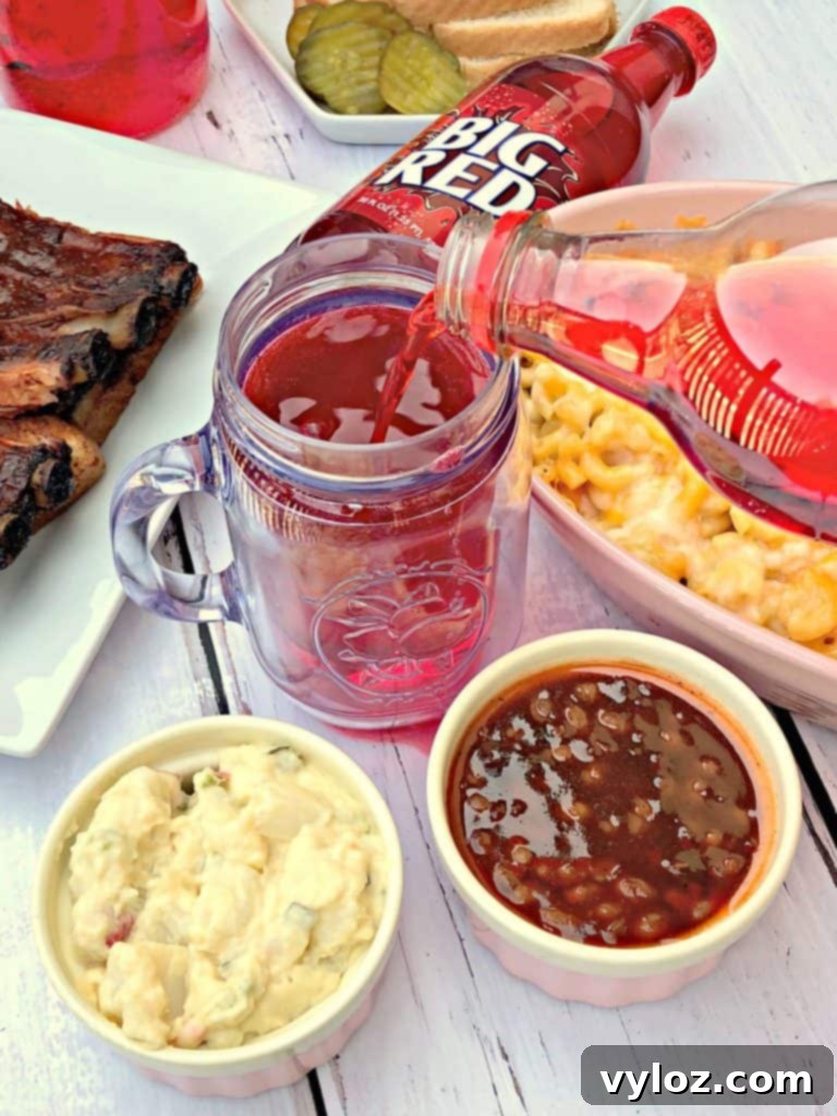 plate of baked mac and cheese, red soda, and various other BBQ side dishes