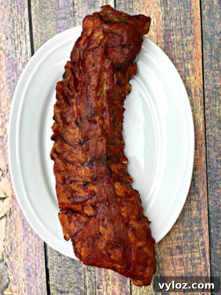 instant pot baby back ribs on a white plate with sauce