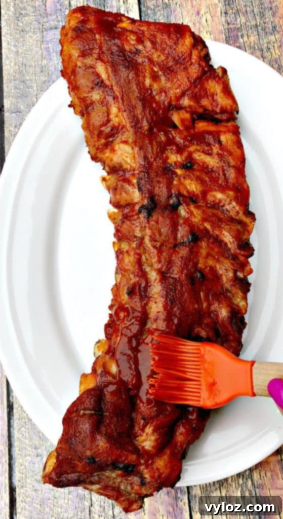 instant pot baby back ribs on a white plate, close up on sauce