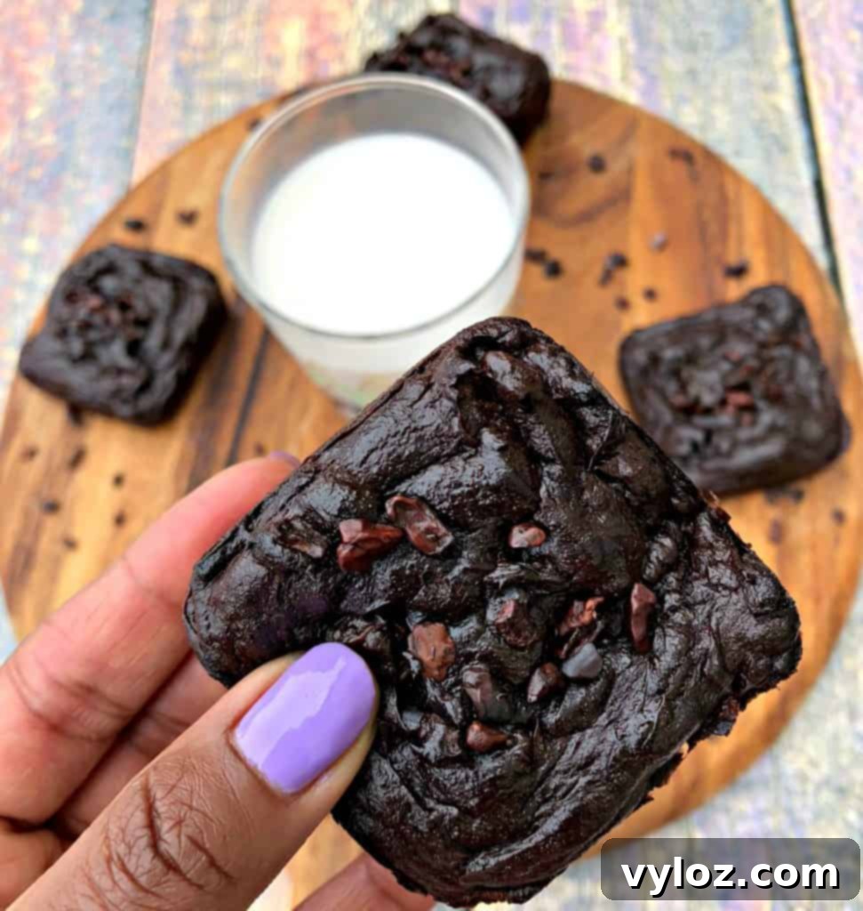 A close-up shot of a keto avocado brownie, showing its moist, fudgy texture