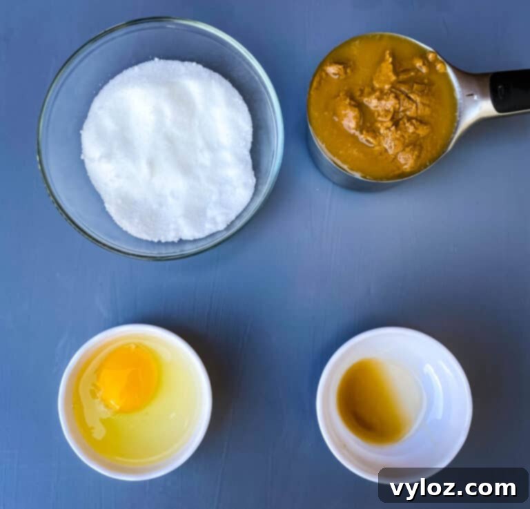 Simple Keto Peanut Butter Cookies 3 natural peanut butter, sugar, egg, and vanilla in bowls