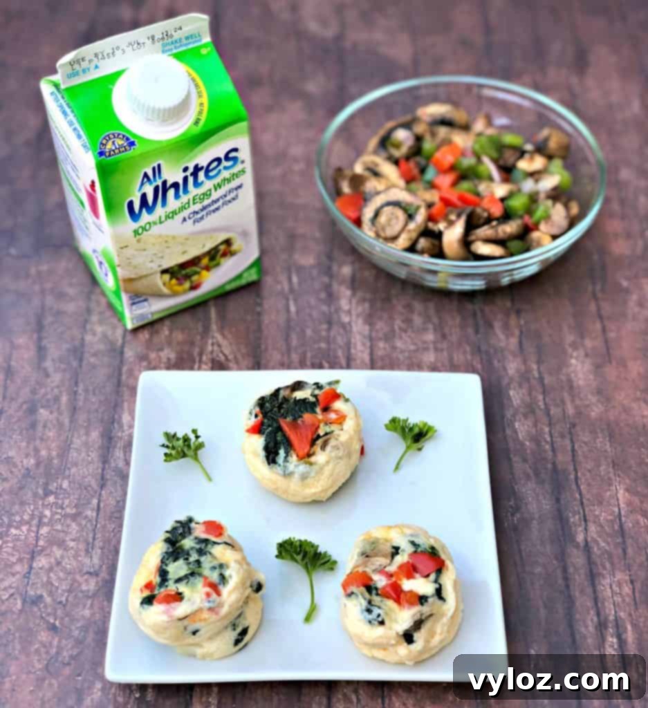 Keto Veggie Egg White Bites 9 An arrangement of Keto Low-Carb Egg White Omelet Vegetable Bites alongside a fresh bowl of colorful chopped vegetables, ready to be incorporated.