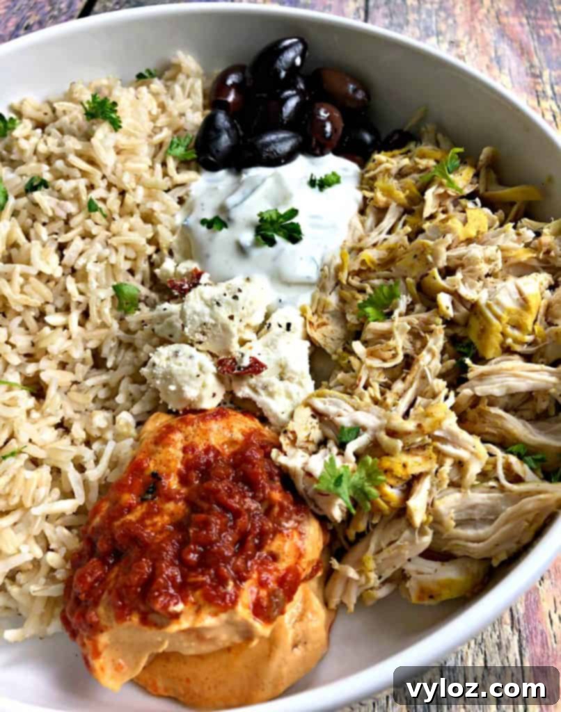 Vibrant Instant Pot Mediterranean Greek Shredded Chicken Brown Rice Bowls 3 close up photo of mediterranean chicken bowl in a white bowl