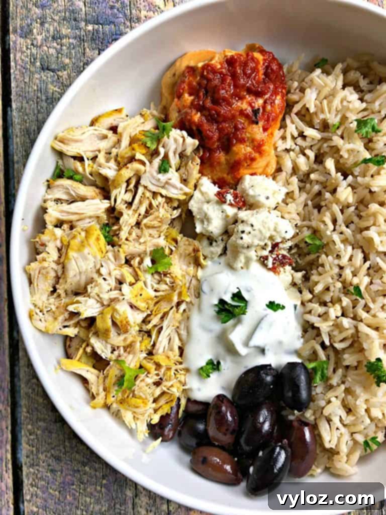 Vibrant Instant Pot Mediterranean Greek Shredded Chicken Brown Rice Bowls 5 mediterranean chicken bowl in a white bowl