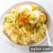Effortless Instant Pot Potato Salad 2 Instant Pot potato salad in a white bowl with boiled eggs and sprinkled with paprika