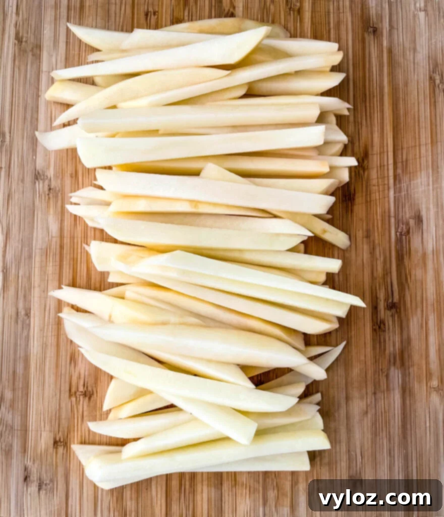 raw sliced potatoes on a cutting board