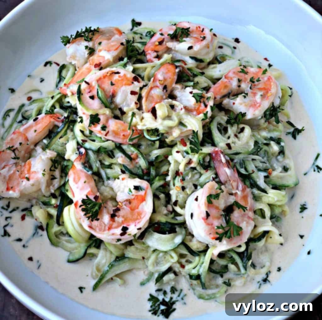low carb zucchini alfredo in cream sauce on a white plate