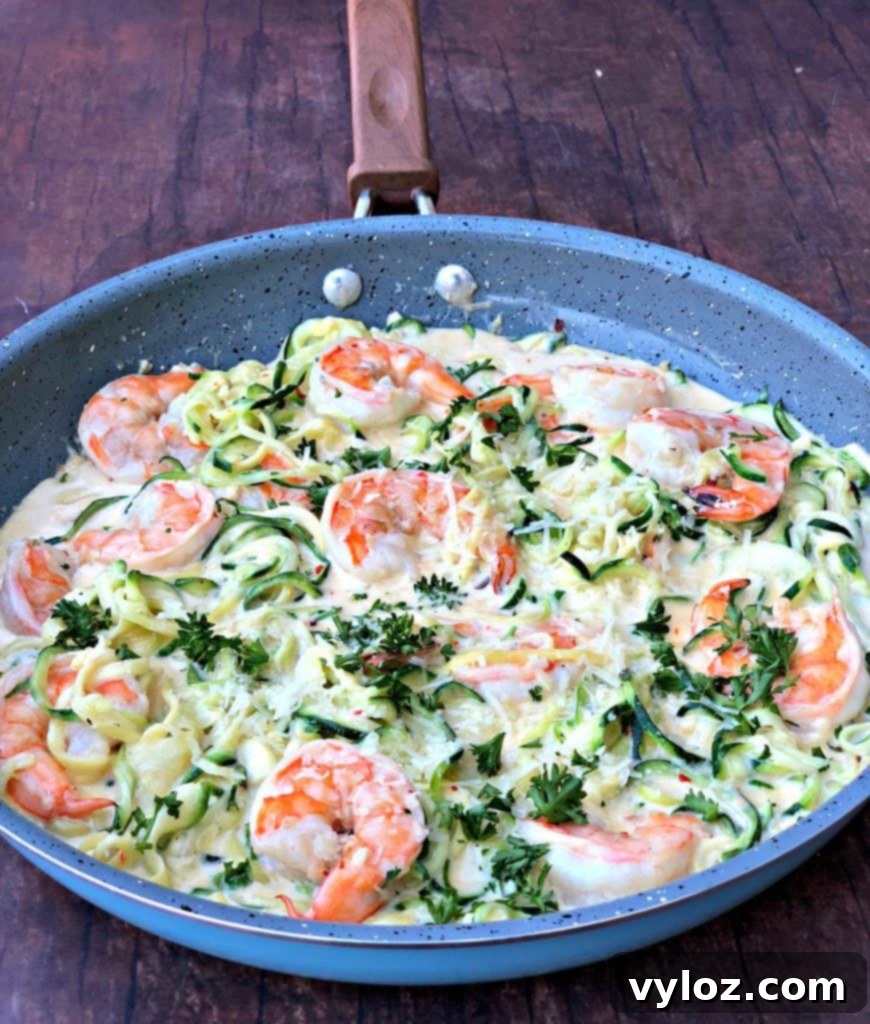 low carb zucchini alfredo in cream sauce in a skillet