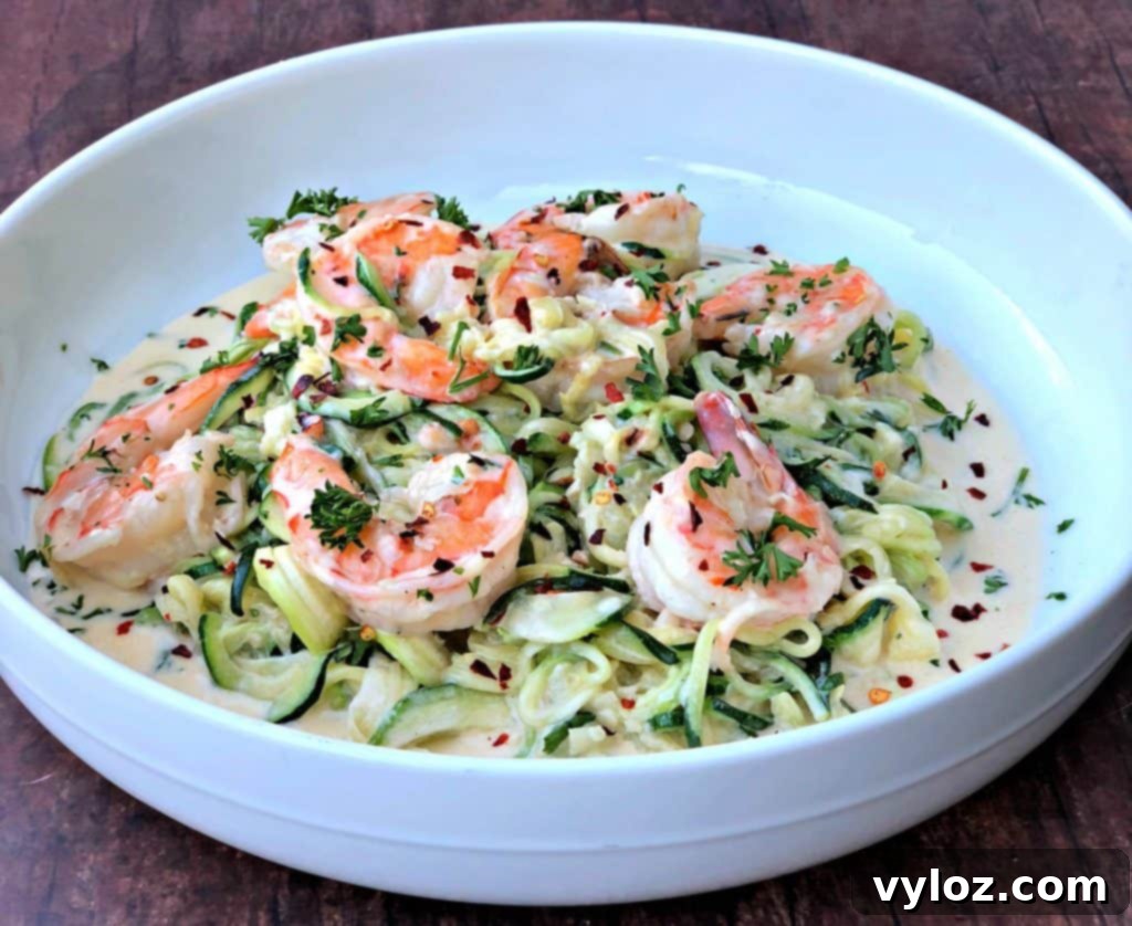 low carb zucchini alfredo in cream sauce on a white plate