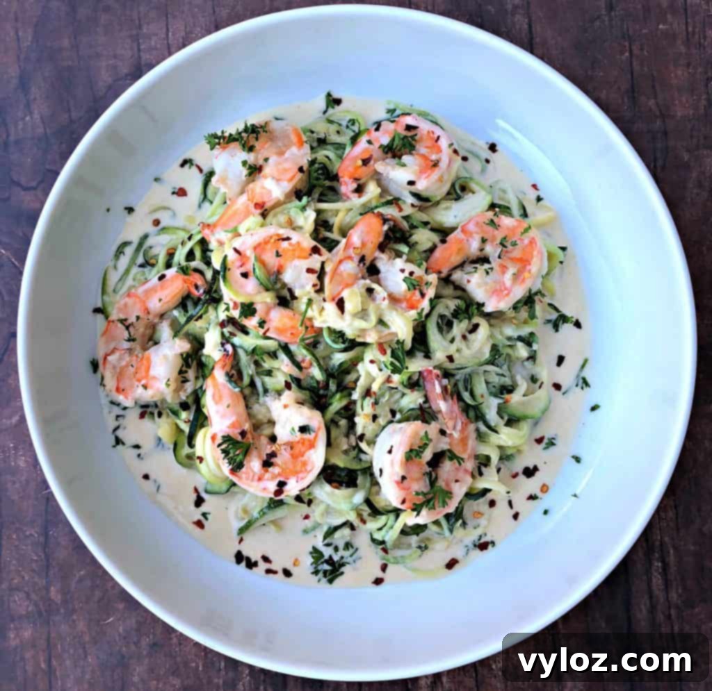 low carb zucchini alfredo in cream sauce on a white plate