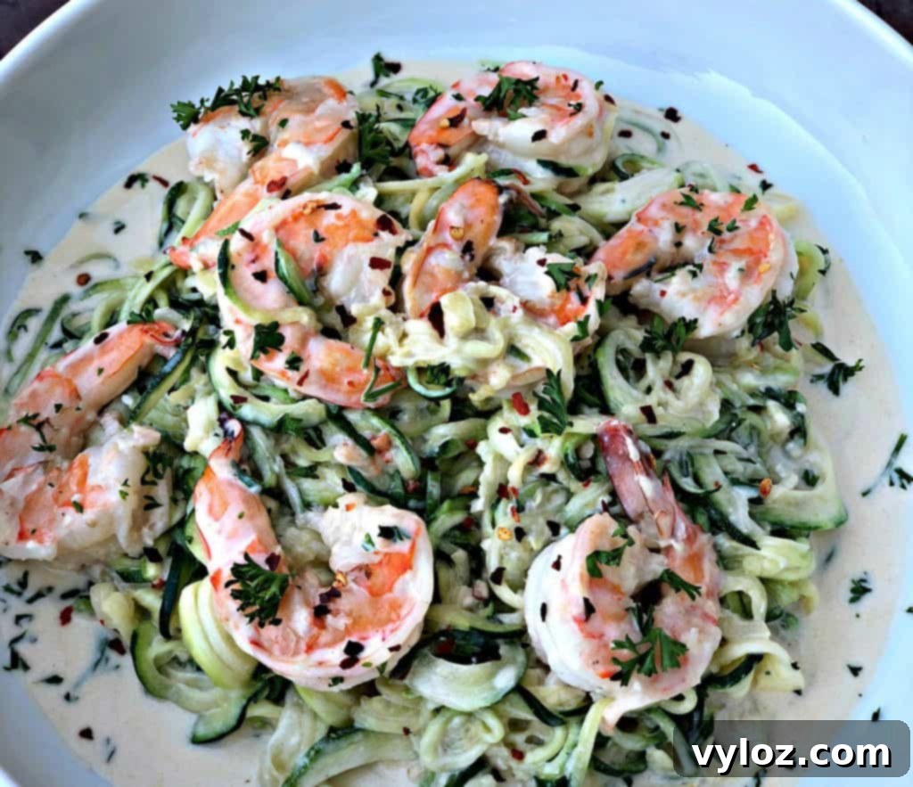 low carb zucchini alfredo in cream sauce on a white plate