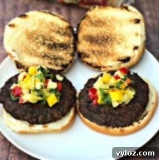 Grilled burgers with tropical salsa on a plate, presented as a finished dish.