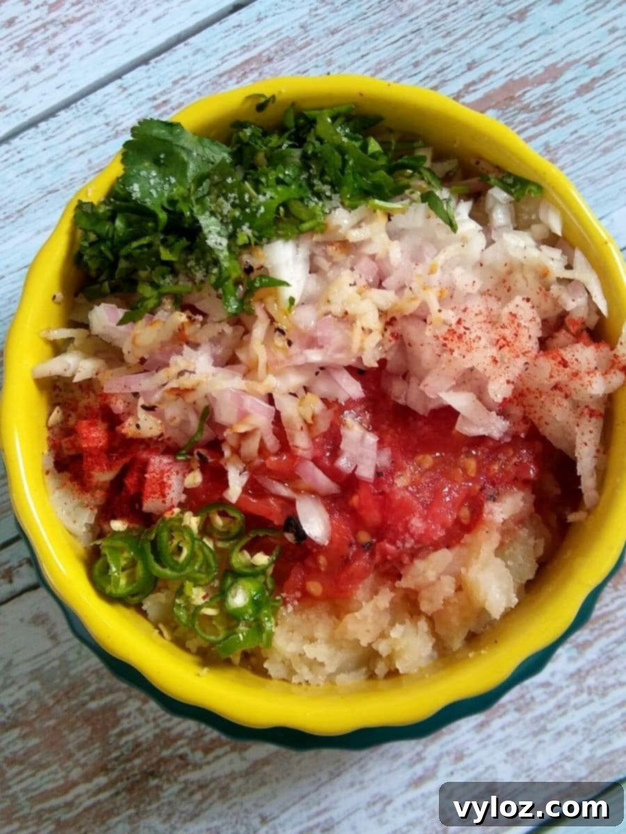 Mixing Ingredients for Spicy Mashed Potato - Aloo Chokha