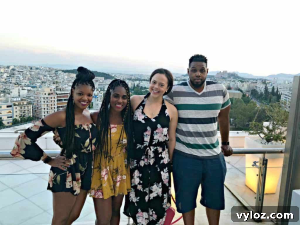 Rooftop dining with city lights of Athens at dusk