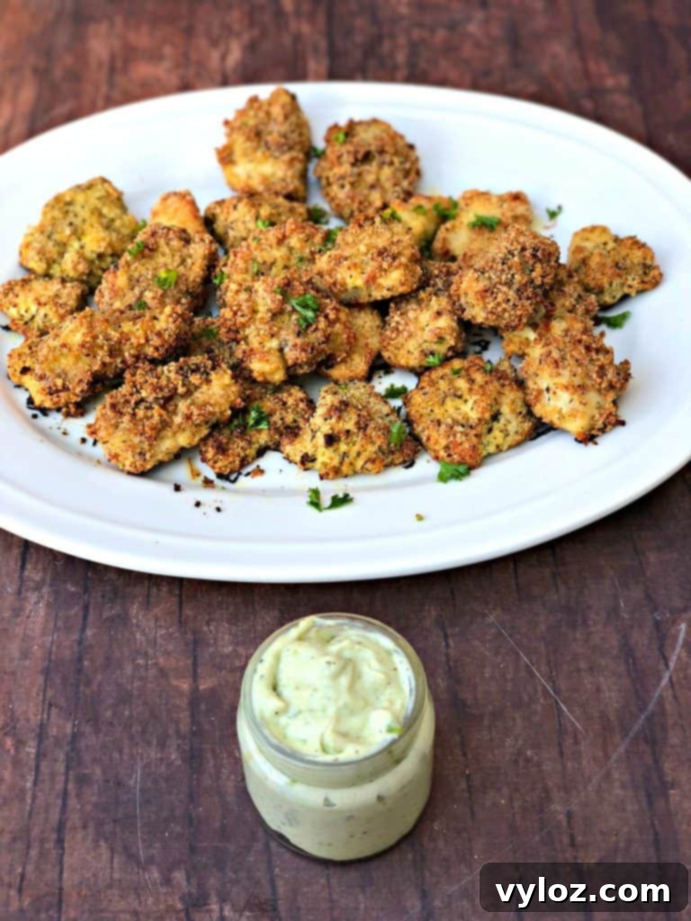 Close-up of keto bacon chicken nuggets on a plate with avocado ranch dip