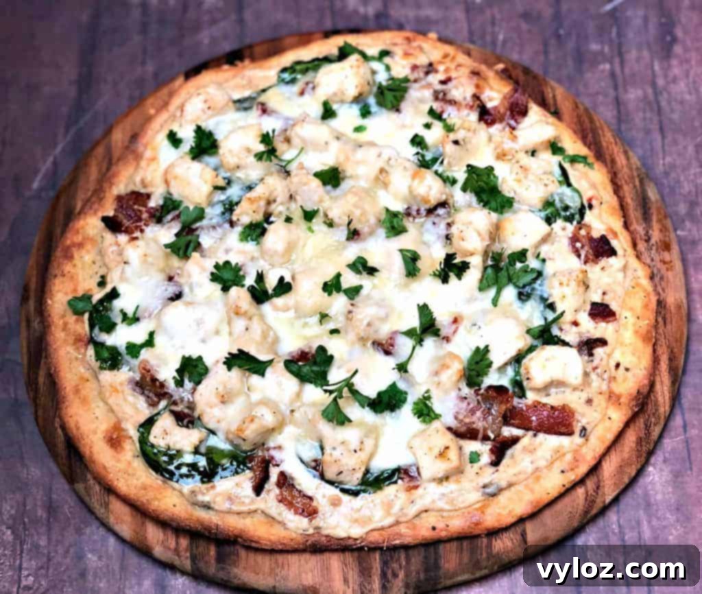 Indulgent Keto Chicken Alfredo Pizza 2 keto fathead alfredo bacon chicken pizza on a pan