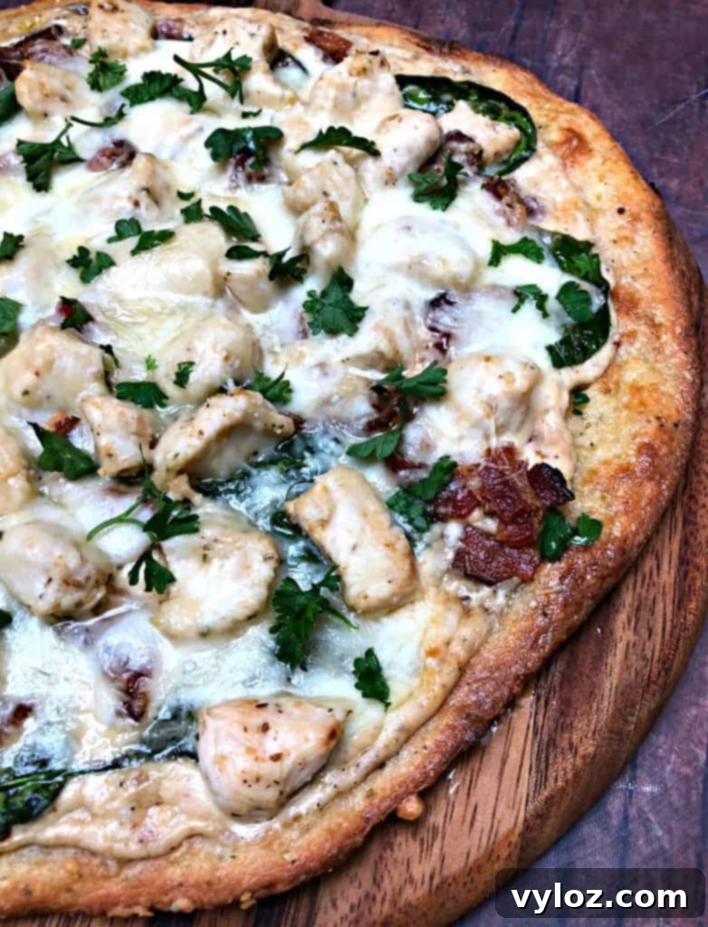 Indulgent Keto Chicken Alfredo Pizza 11 keto fathead alfredo bacon chicken pizza on a pan