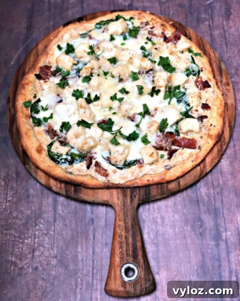Indulgent Keto Chicken Alfredo Pizza 4 keto fathead alfredo bacon chicken pizza on a pan