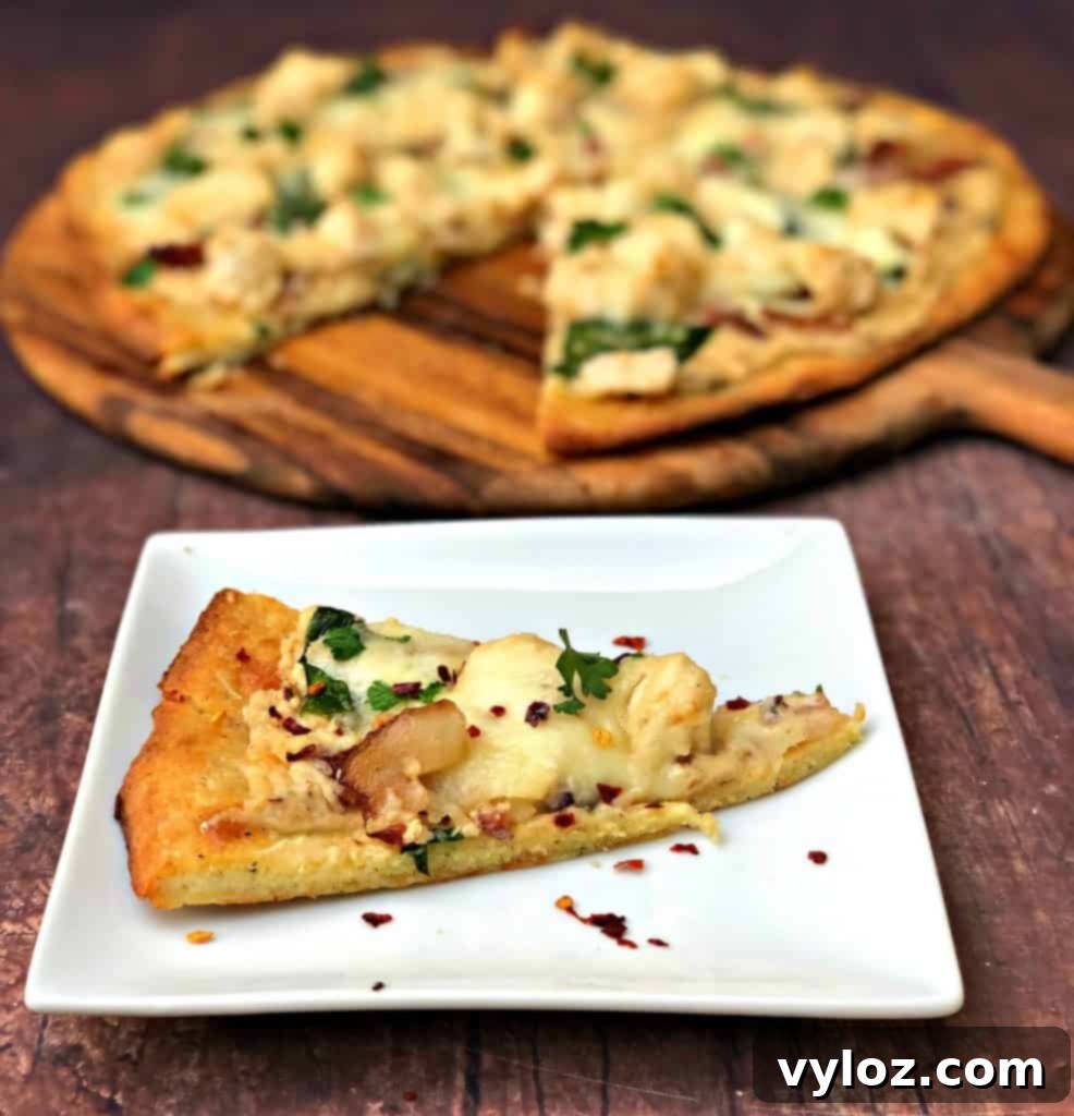 Indulgent Keto Chicken Alfredo Pizza 8 keto fathead alfredo bacon chicken pizza sliced and on a plate