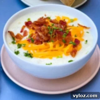 Loaded Instant Pot Baked Potato Soup 11 Instant Pot baked potato soup with bacon and cheese in a white bowl