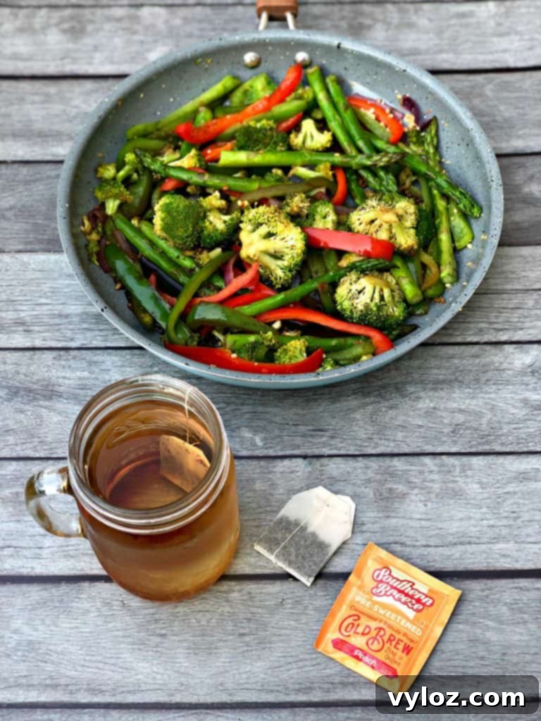 A close-up shot of seasoned vegetables simmering in a skillet, highlighting the textures and colors.