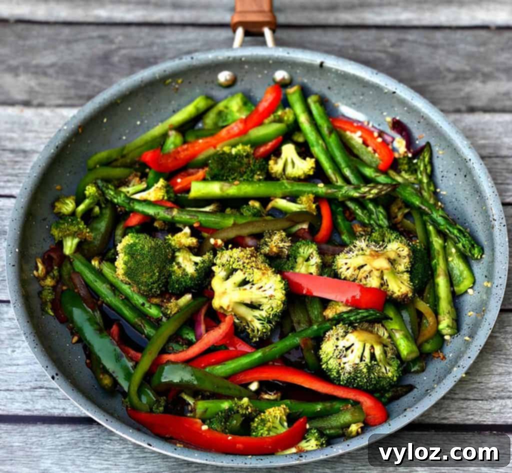 A serving of low-carb vegetable stir fry in a bowl, garnished and ready to eat.
