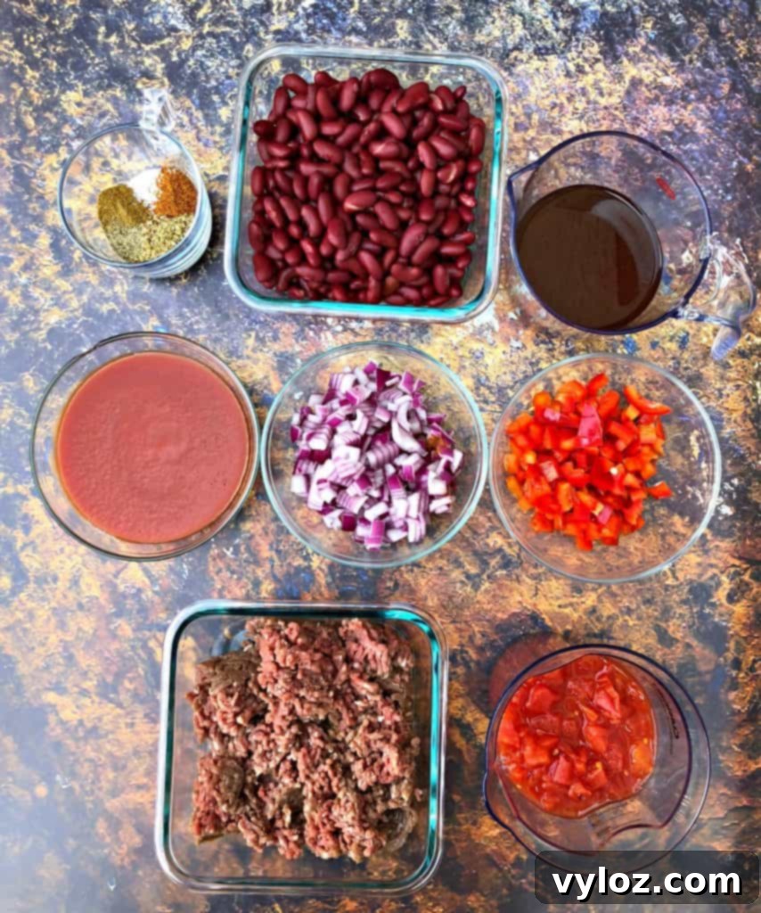 Close-up of Instant Pot beef chili with a spoon, highlighting its rich texture and ingredients.
